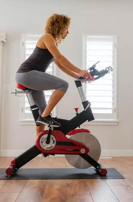 A rider using an indoor cycling bike